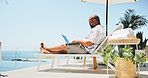 Laptop, writing and relax with black man at pool for luxury travel expert, hotel rating and research. Online review, Digital nomad critic, vacation and remote work with person at resort for blog
