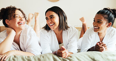 Buy stock photo Women, friends and happy on bed at spa with talking, laugh and funny memory on vacation with diversity. People, group and smile for conversation, comic chat and holiday in hotel room with bonding