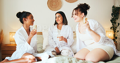 Buy stock photo Bridesmaids, happy friends and women with champagne in bedroom for relax, talk or gossip at sleepover. Wine, girls or together at bachelorette in hotel for hen party, social event and bridal shower
