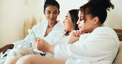 Buy stock photo Women, friends and phone in bedroom at spa with sharing, talk and relax with memory on vacation together. People, group and smile with smartphone, mobile app and social media for bonding at resort