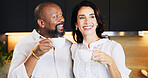 Happy, interracial and couple with coffee in kitchen for caffeine start, morning routine and bonding together. Mature, people and warm beverage with laughing, funny discussion and commitment at house