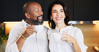 Buy stock photo Happy, interracial and couple with coffee in kitchen for caffeine start, morning routine and bonding together. Mature, people and warm beverage with laughing, funny discussion and commitment at house
