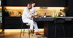 Planning, laptop and success with interracial couple in kitchen for travel itinerary, flight booking and vacation package. Passport approval, smile and airline review with man and woman at home