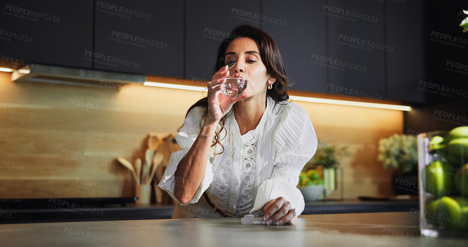 Buy stock photo Woman, medicine and drink water in kitchen for supplement pills, vitamins and tablets for menopause. Female person, hydrate and beverage of drugs container, diet nutrition and detox treatment at home