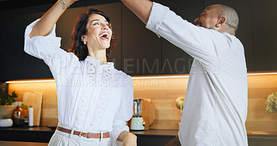 Buy stock photo Happy, interracial couple and dancing with twirl for love, romance or bonding together in kitchen at home. Man, woman or lovers with smile or support for weekend, swirl or romantic steps at house