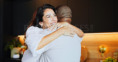 Buy stock photo Hug, smile and mature interracial couple in kitchen with home, bonding and marriage or romance. Safety, security and trust with man, woman and embrace in modern apartment for anniversary celebration