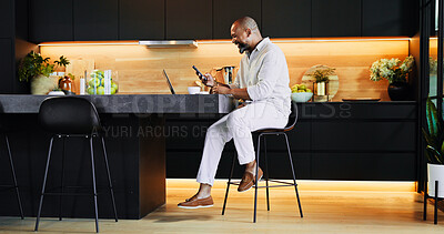 Buy stock photo Remote work, phone and black man in kitchen with laptop for research, online networking and website. Professional, home and person with smartphone for finance consulting, insurance and planning