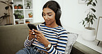 Headphones, online and woman with phone on sofa for social media, streaming subscription and radio. Happy, home and girl on smartphone listening to audio, playlist and podcast to relax in living room