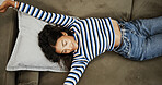 Girl, happy and stretching on sofa in home for wake up, relax and muscle tension relief from nap. Top view, person and smile in lounge for weekend break, resting and comfortable sleep in apartment