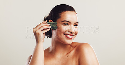 Buy stock photo Happy woman, portrait or skincare with gua sha for anti aging facial or healing technique on a white studio background. Face, female person or model with smile, massage or beauty tool for circulation