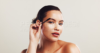 Buy stock photo Woman, portrait and beauty with eyelashes for makeup, cosmetics or mascara on a white studio background. Female person, tool and filler with stick for volume, curl or color thickness on mockup space