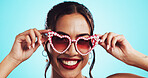 Woman, heart sunglasses and studio for fashion accessories, designer frames and blue background. Shades, confident portrait and trendy eyewear for valentines day holiday, stylish and date celebration