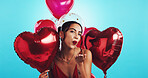 Portrait, studio and woman with balloons, kiss and gift for date on valentines day, heart and flirting. Blue background, happy and person with smile for anniversary, romance or celebration for love