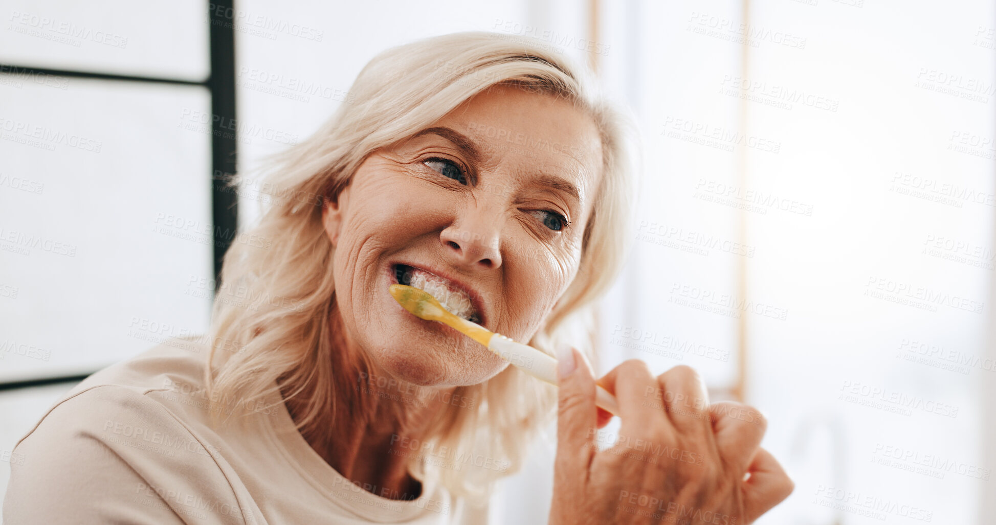 Buy stock photo Senior woman, toothbrush and cleaning in home, brushing teeth and tool to remove plaque in bathroom. Dental hygiene, prevent bad breath and morning routine for healthy gums, oral care and treatment