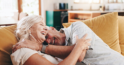 Buy stock photo Senior couple, hug and laugh with care, support and embrace for bonding on living room sofa together. Happy mature man, woman and smile for romance, weekend break and funny joke in retirement home