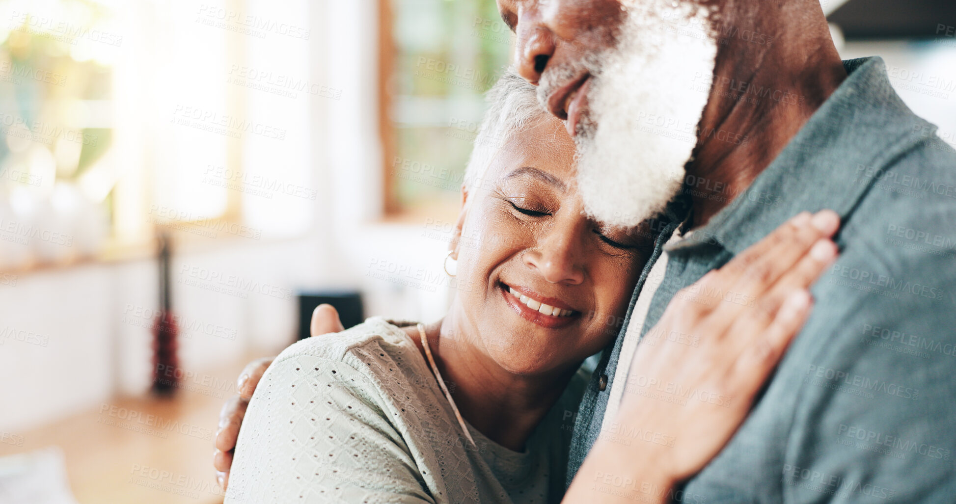 Buy stock photo Home, senior couple and hug for love, support or connection to partner in marriage. Interracial, happy woman and man embrace for romantic relationship, loyalty and commitment in retirement together