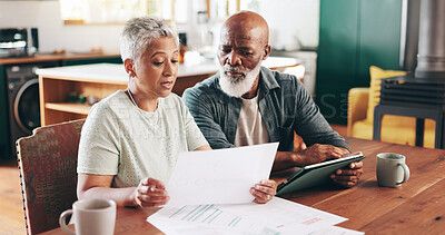 Buy stock photo Mature, interracial couple and documents with tablet for financial discussion, planning or expenses at home. Man, woman or mortgage with paperwork or technology for payment due, finance or bills