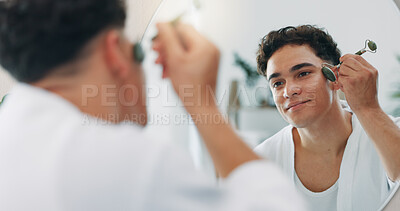 Buy stock photo Mirror, man and jade roller for skincare, beauty and morning routine in home bathroom. Face, stone and reflection with cosmetics for facial massage, treatment and blood circulation for dermatology