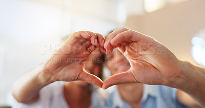 Buy stock photo Heart hands, trust and couple in home with love sign, support and smile for anniversary. Finger, shape or people in apartment with kindness emoji, romance or care for valentines day, date or bonding