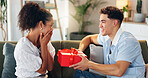 Love, gift and surprise with couple on sofa for valentines day celebration, box or bonding. Relationship, care and romance with man and woman at home for support, connection or present together