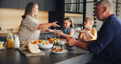 Buy stock photo Parents, children and serving breakfast in kitchen with healthy food, sandwich and eating together. Happy family, people and kids with lunch meal in home for hunger, wellness and bonding at table