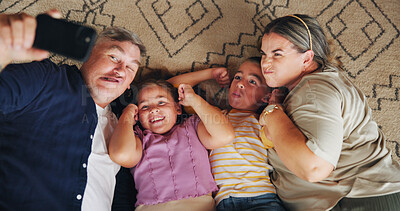 Buy stock photo Selfie, silly and above of parents with children for memory, profile picture and social media post. Family, home and mom, dad and kids take photo on floor for bonding, love and relax in living room