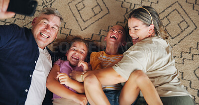 Buy stock photo Selfie, laugh and above of parents with children for memory, profile picture and social media post. Family, home and mom, dad and kids take photo on floor for bonding, love and relax in living room