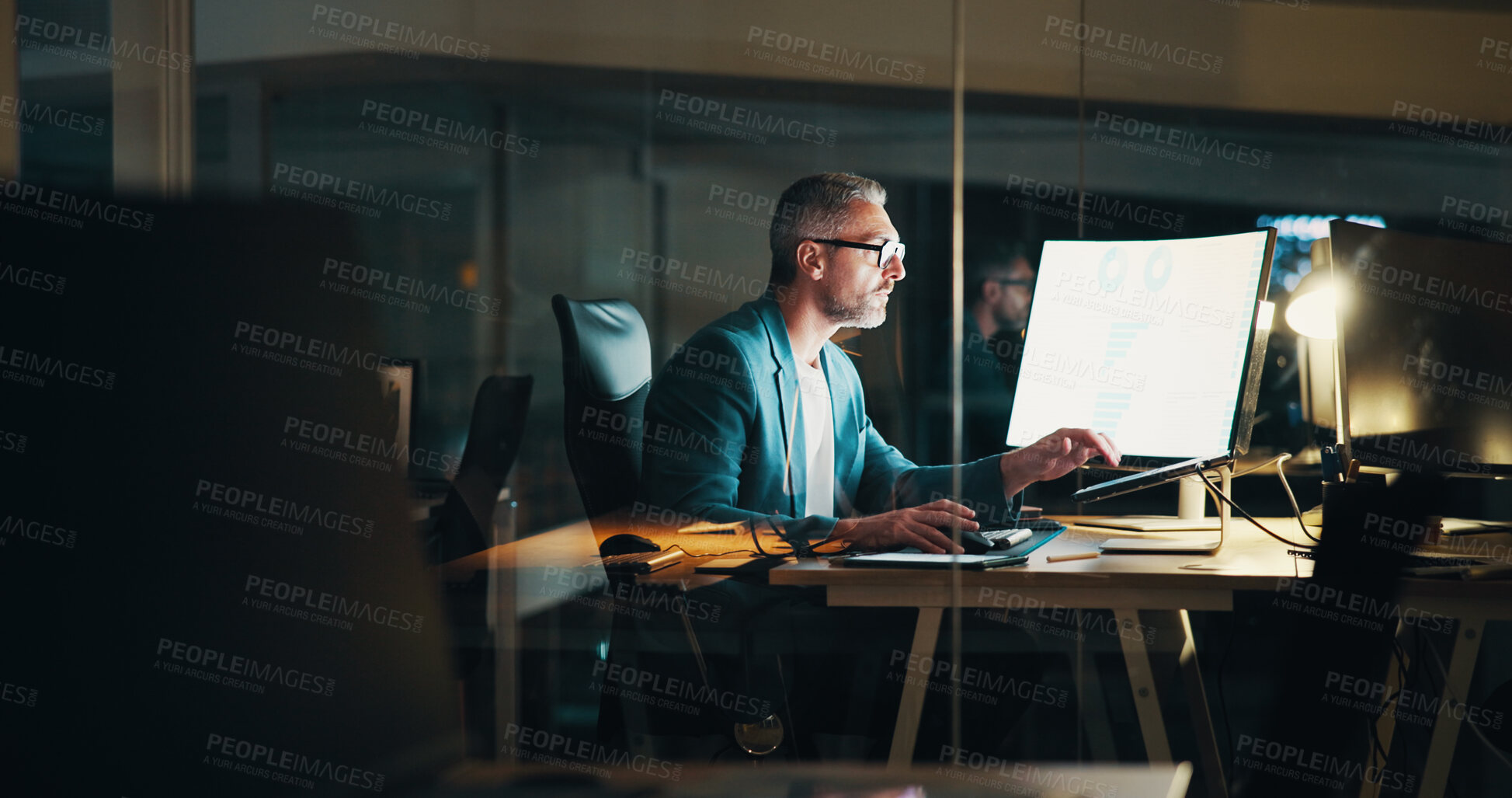 Buy stock photo Office, night and business man on computer with statistics for finance report, research and analytics. Corporate, company and mature person working late for financial planning, review and fintech