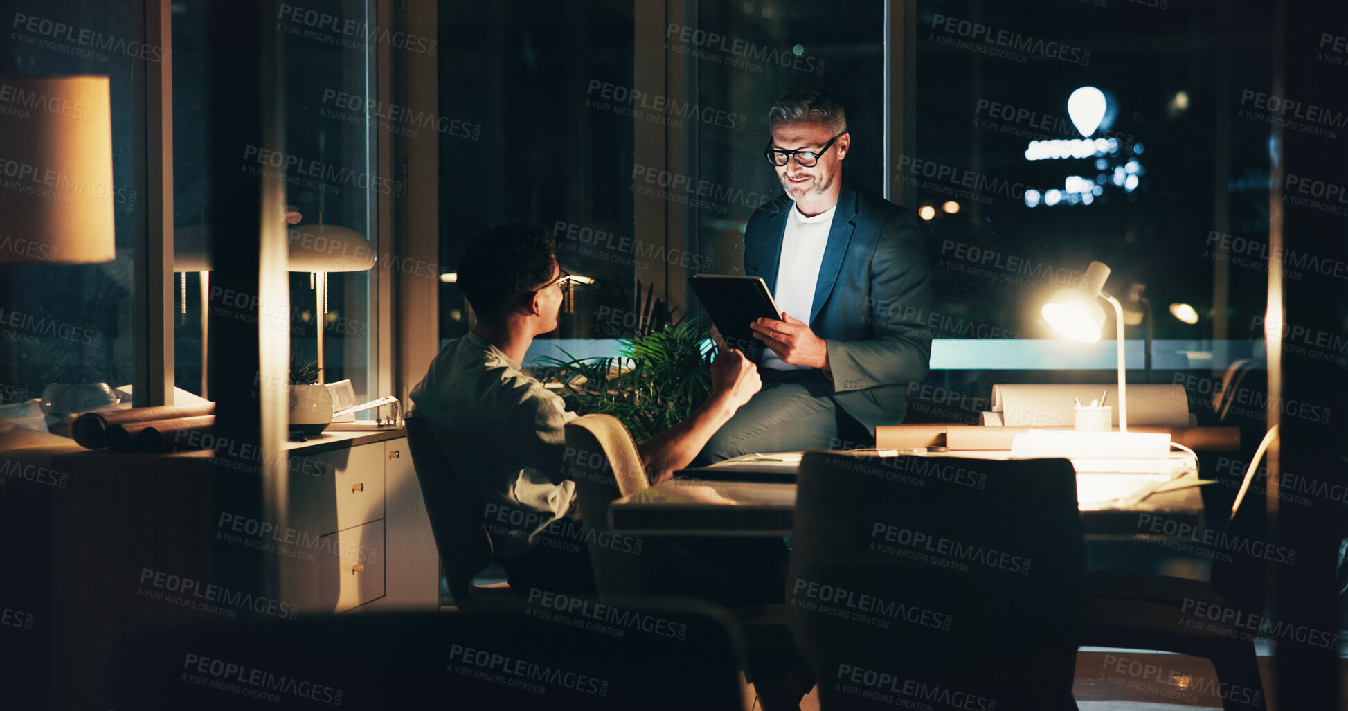 Buy stock photo Programmer, night meeting and tablet for review, feedback or overtime work for agency performance. Business men, mentor and collaboration for web design, project teamwork or website strategy deadline