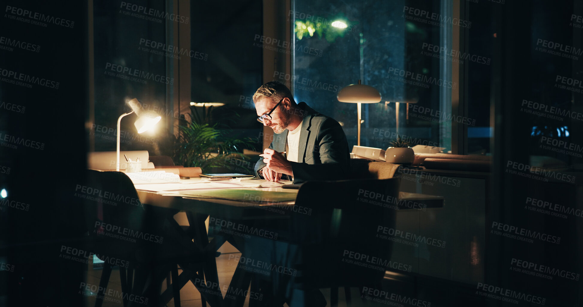 Buy stock photo Architecture, night and mature man in office for urban planning, property design and floorplan. Creative agency, working late and architect with layout, blueprint and paperwork for building project