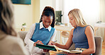 Women, interns and tablet with book in meeting for research, learning or education at office. Female people, friends or junior therapists with technology or notes for lesson or session at workshop