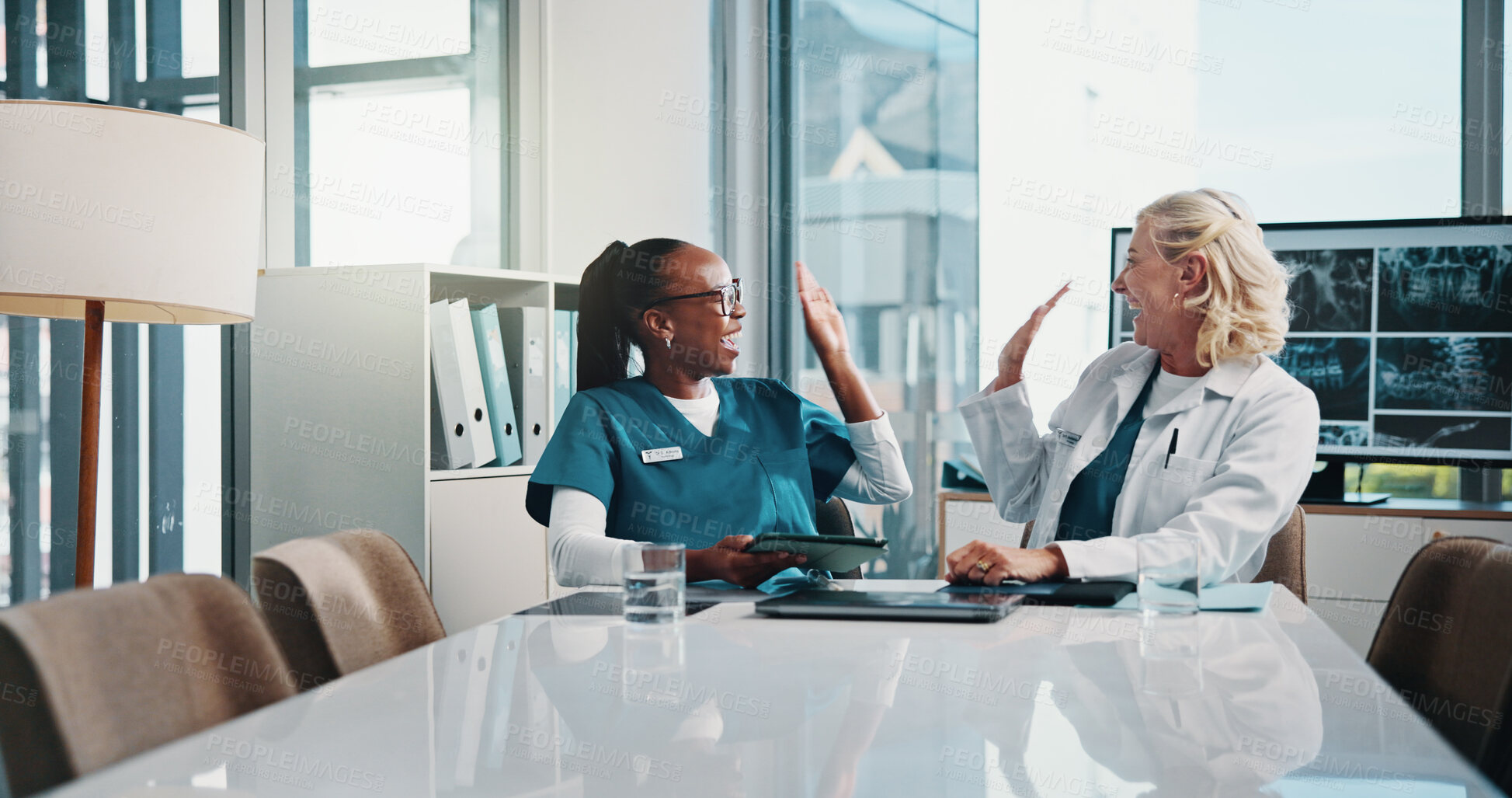 Buy stock photo High five, doctor and medical student in hospital with xray for surgery planning in collaboration. Women, technology and mature surgeon with healthcare intern for teaching treatment with MRI scan.