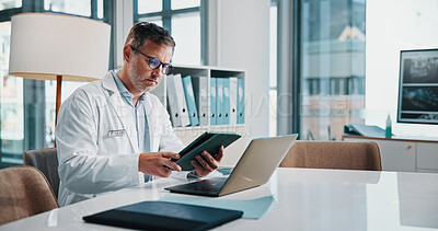 Buy stock photo Healthcare, laptop and tablet with doctor man at desk in office of hospital for diagnosis, planning or research. Computer, medical and technology with mature medicine professional reading in clinic