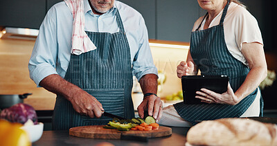 Buy stock photo Tablet, couple cooking and hands cut vegetables in kitchen with online tutorial, recipe or organic food guide. Senior man, woman and technology for meal ingredients or salad on chopping board in home
