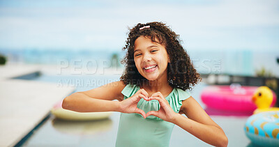 Buy stock photo Happy girl, portrait and pool with heart hands for vacation, summer holiday or swim at resort. Female person, child or kid with smile, emoji or shape for love, care or support at luxury getaway
