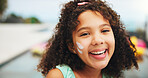 Outdoor, portrait and child with sunscreen for skincare, sunburn prevention and wellness on holiday. Poolside, female person and happy girl with spf cream for cosmetics, UV protection and vacation
