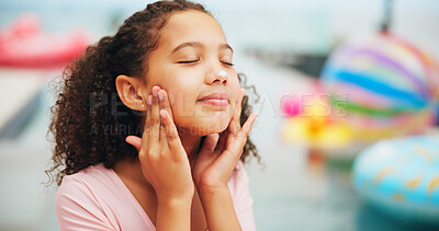 Buy stock photo Outdoor, apply and kid with sunscreen for skincare, sunburn prevention and wellness on holiday. Face, female child and calm girl with spf cream for cosmetics, UV protection and vacation by poolside