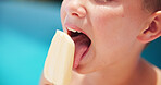 Closeup, boy and kid with ice lolly, swimming pool and summer holiday with weekend break. Taste, outdoor and child with cold treatment, eating and sweet snack to cool down, calm and hydration