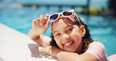 Buy stock photo Child, sunglasses and happy girl in portrait by swimming pool for holiday, travel or outdoor vacation. Smile, summer and kid sunbathing in water at lodge, hotel or resort on weekend break in Miami
