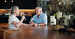 Wine, holding hands and elderly couple in home, celebration and love partnership on valentines day. Talking, affection and loyalty to spouse in relationship, trust and glasses of alcohol for date