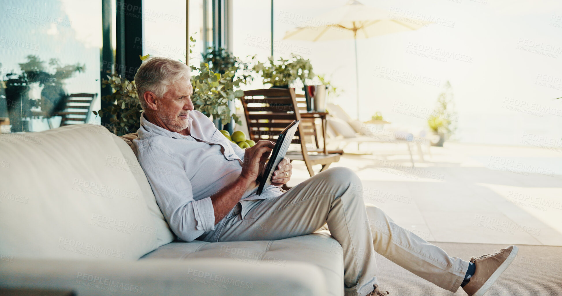 Buy stock photo Outdoor, relax and senior man with tablet, typing and internet with email notifications. Mature person, comfort or guy on sofa, break and house with connection, digital app or communication with tech