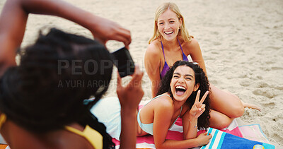Buy stock photo Camera, women or friends at sea with smile, funny joke or reunion for photography on holiday. Peace sign, laugh or happy people bonding together on break for picture, fun memory or diversity at beach