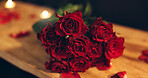 Valentines day, roses and decor for romance, restaurant and closeup of petals on table, classy and love. Red flowers, floral arrangement and gift for anniversary on date, commitment and luxury