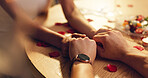 Couple, holding hands and love on date at restaurant for valentines day, romantic dinner and celebration. People, closeup and affection of fine dining, anniversary bonding and relationship commitment