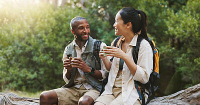 Buy stock photo Smile, coffee and hiking with interracial couple in nature for lunch break, trekking adventure and park for travel. Drinking, conversation and environment with man and woman in forest for tea