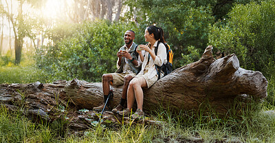 Buy stock photo Relax, coffee and hiking with interracial couple in nature for travel break, trekking adventure and park conservation. Talking, conversation and environment with man and women in forest for peace