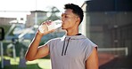 Sports athlete, fitness and man drinking water for thirst hydration, exercise break or liquid refreshment. Healthy, person or mineral drink outdoor for workout recovery, body detox or cardio training