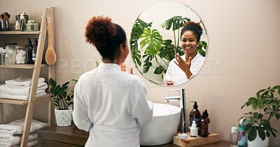 Buy stock photo Beauty, woman and face cream in mirror of bathroom for skin hydration, getting ready or cosmetics self care. Reflection, girl or lotion application in home for anti aging, morning routine or skincare