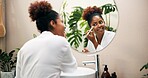 Happy woman, mirror and brush with makeup for beauty, cosmetics or morning in bathroom at home. Female person, face or applying foundation with smile or reflection for cosmetology or facial at house