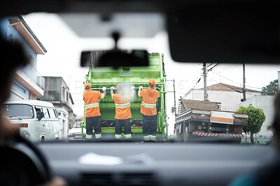 Buy stock photo Cropped rear view shot of a garbage collection team at work